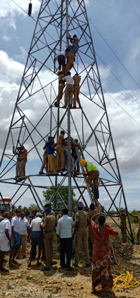 farmers against high voltage tower